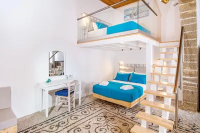 a small bedroom with a bunk bed and a desk at The red door in Koskinou in Koskinou