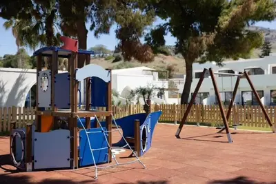 a playground with a slide and a swing set at Aiora Aqua Resort in Pefki Rhodes