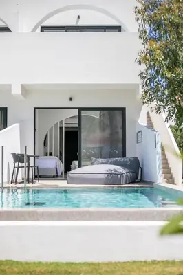 a bedroom and a pool in a house at Aiora Aqua Resort in Pefki Rhodes