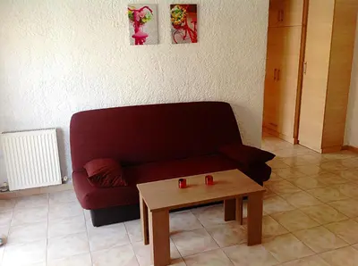 a living room with a couch and a coffee table at Aialion studios & apartments - Steve Apartments in Rhodes Town