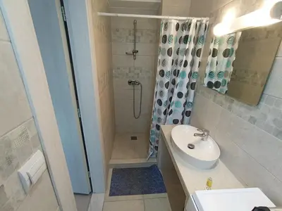 a bathroom with a shower and a sink and a toilet at Aialion studios & apartments - Steve Apartments in Rhodes Town