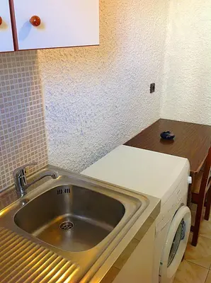a kitchen with a stainless steel sink and a counter at Aialion studios & apartments - Steve Apartments in Rhodes Town