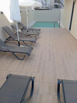 a row of chairs and tables in a room at Aialion studios & apartments - Steve Apartments in Rhodes Town