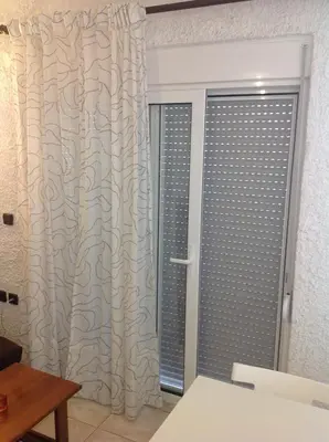 a room with a sliding glass door with a window at Aialion studios & apartments - Steve Apartments in Rhodes Town
