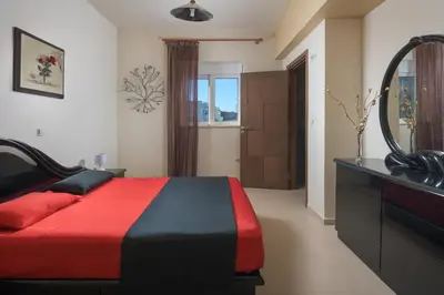a bedroom with a bed and a mirror and a dresser at Dreamcatcher Villa in Pastida