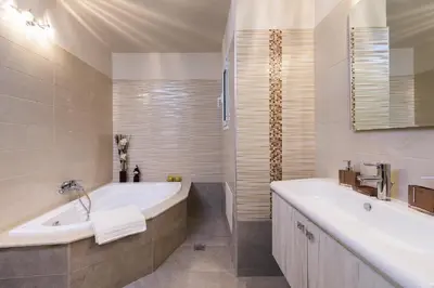 a white bathroom with a tub and a sink at Dreamcatcher Villa in Pastida