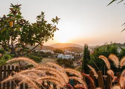a view of a village at sunset from a fence at Dreamcatcher Villa in Pastida
