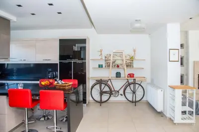 a kitchen with a table with a bike in it at Villa Elena in Triánta