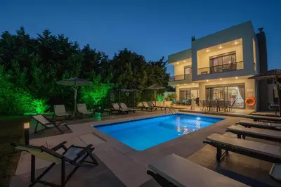 a house with a swimming pool and some chairs at Villa Elena in Triánta