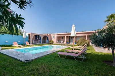 a villa with a swimming pool and a house at Afandou Beach Villas Sofias in Afantou