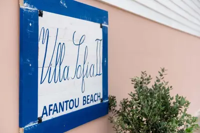 a blue and white sign on the side of a building at Afandou Beach Villas Sofias in Afantou