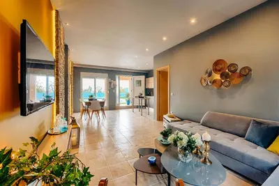 a living room with a couch and a table at Afandou Beach Villas Sofias in Afantou