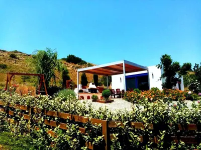 a garden with a pavilion in a field of flowers at Villa Dimitrios in Kiotari