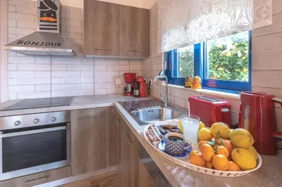a kitchen with a bowl of fruit on a counter at Villa Dimitrios in Kiotari