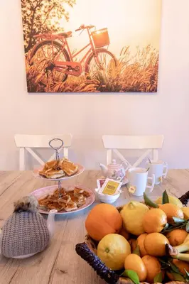 a table with a plate of food and a bike at Villa Dimitrios in Kiotari