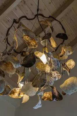 a chandelier hanging from a ceiling with rocks at The Vegghera House in Symi