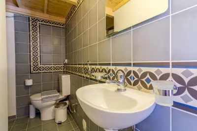 a bathroom with a sink and a toilet at The Vegghera House in Symi