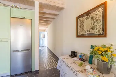 a kitchen with a table and a refrigerator at The Vegghera House in Symi