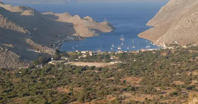 a view of a bay with a group of sailboats at Pedi Beach Hotel in Symi