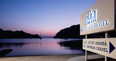 a sign in front of a body of water at Pedi Beach Hotel in Symi