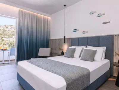 a bedroom with a large bed in a room at Blue Sea Beach Resort in Faliraki