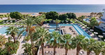 an aerial view of a resort with a pool and palm trees at Blue Sea Beach Resort in Faliraki