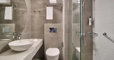a bathroom with a toilet and a sink and a shower at Blue Sea Beach Resort in Faliraki