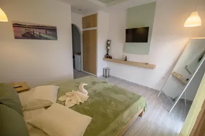 a living room with a swan sitting on a table at Maroula Studios in Faliraki