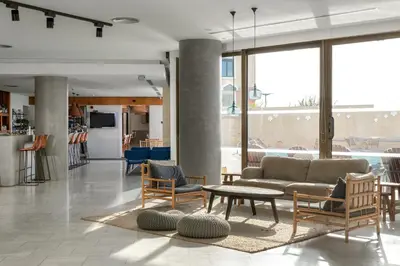 a living room with a couch and chairs and a table at Blue Sky City Beach Hotel in Rhodes Town