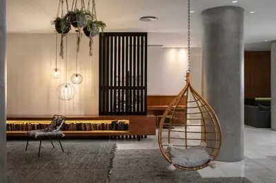 a living room with a couch and a swing at Blue Sky City Beach Hotel in Rhodes Town