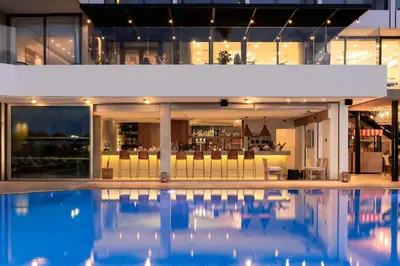an indoor pool with a bar in a building at Blue Sky City Beach Hotel in Rhodes Town