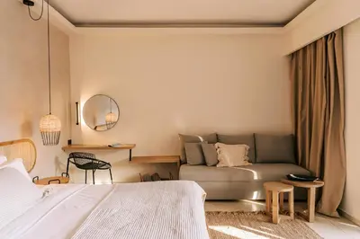 a bedroom with a bed and a couch at Villa Di Mare Seaside Suites in Ixia