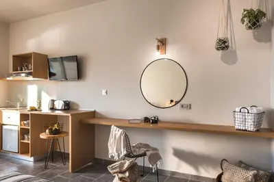 a room with a vanity and a mirror on the wall at Villa Di Mare Seaside Suites in Ixia
