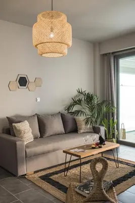 a living room with a couch and a table at Villa Di Mare Seaside Suites in Ixia