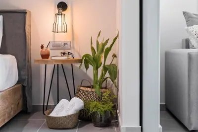 a bedroom with a plant and a table with shoes at Villa Di Mare Seaside Suites in Ixia