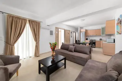 a living room with a couch and a table at Kolymbia Village in Kolimbia