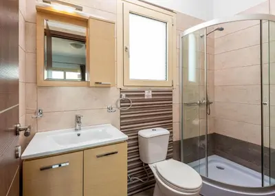 a bathroom with a toilet and a sink and a shower at Kolymbia Village in Kolimbia