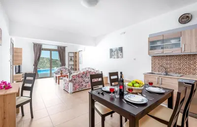 a kitchen and living room with a table and chairs at Kolymbia Village in Kolimbia