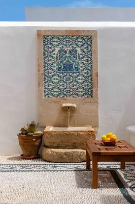 a bathroom with a sink with a tap and a table at Villa Anastasia in Líndos