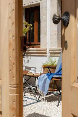 a table and chair in front of a building at Villa Anastasia in Líndos