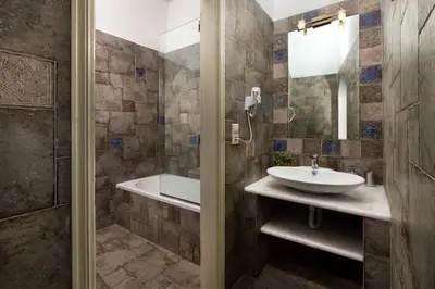 a bathroom with a sink and a tub at Villa Eleni with Hot Tub and Acropolis View in Líndos