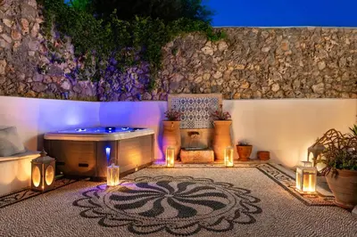 a jacuzzi tub in a room with lights at Villa Eleni with Hot Tub and Acropolis View in Líndos