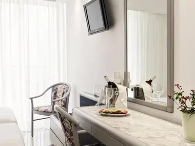 a room with a counter with wine glasses and a mirror at Esperia City Hotel in Rhodes Town