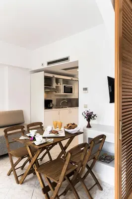 a dining room with a table and chairs in a kitchen at Esperia City Hotel in Rhodes Town