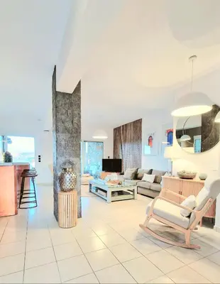 a living room with a couch and a table at Villa Lindos Kalliopi on Rhodes AMA 0 0 0 0 3 6 6 0 4 0 3 in Líndos