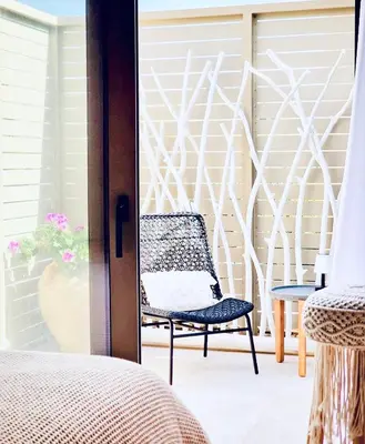 a chair sitting on a patio with a sliding glass door at Villa Lindos Kalliopi on Rhodes AMA 0 0 0 0 3 6 6 0 4 0 3 in Líndos
