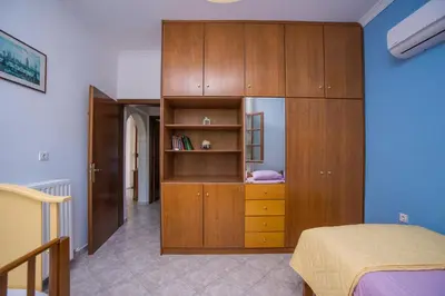 a bedroom with a wooden cabinet and a bed at Lila's house in Eleoúsa