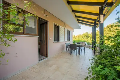 a patio with a table and chairs on it at Lila's house in Eleoúsa