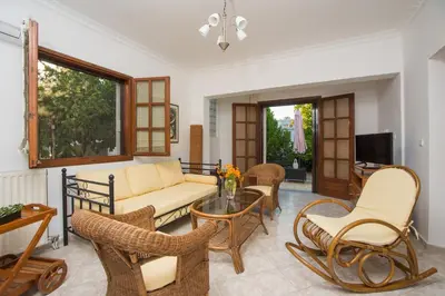 a living room with a couch and chairs and a table at Lila's house in Eleoúsa