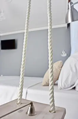 a room with two hanging ropeods in front of a bed at Alkyoni City Apartment in Rhodes Town